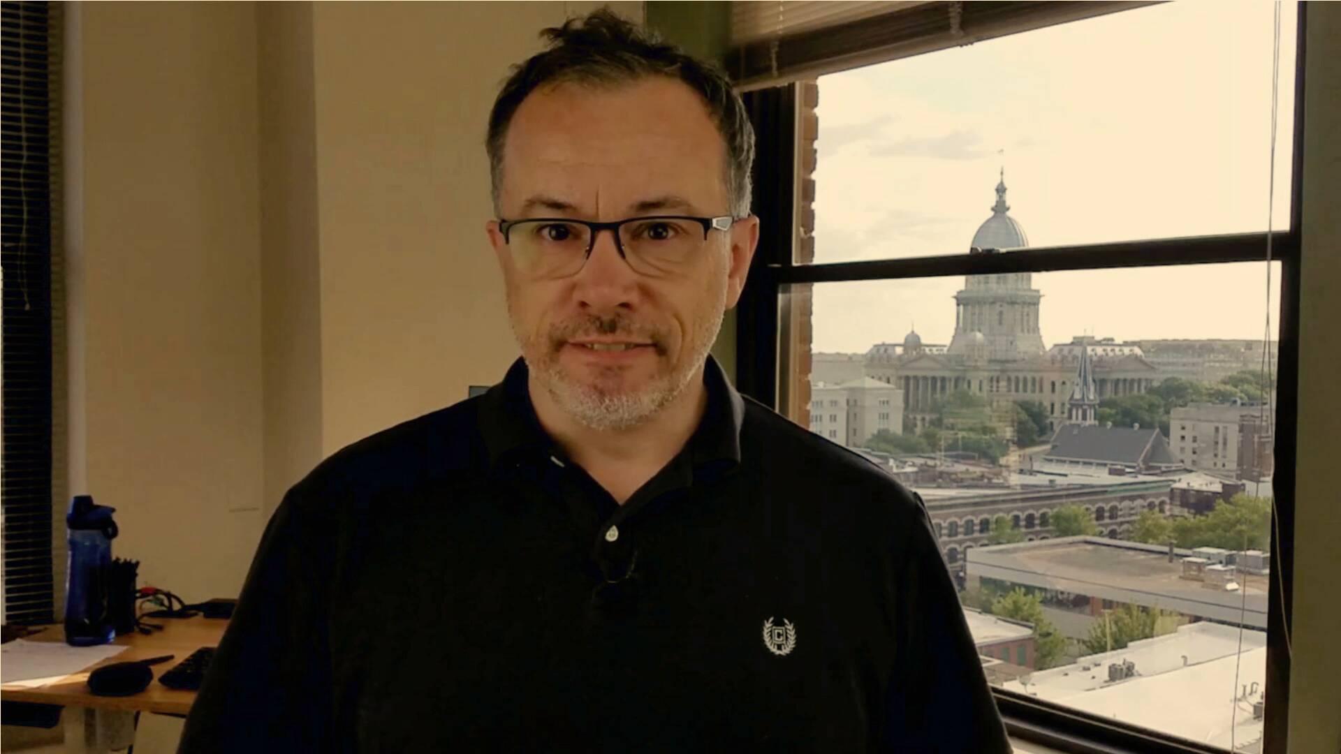 Johnny Molson speaking in front of window near capital in September 2019