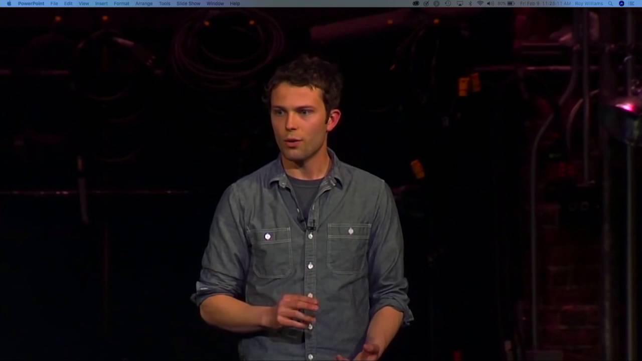 Screenshot of young man speaking on stage