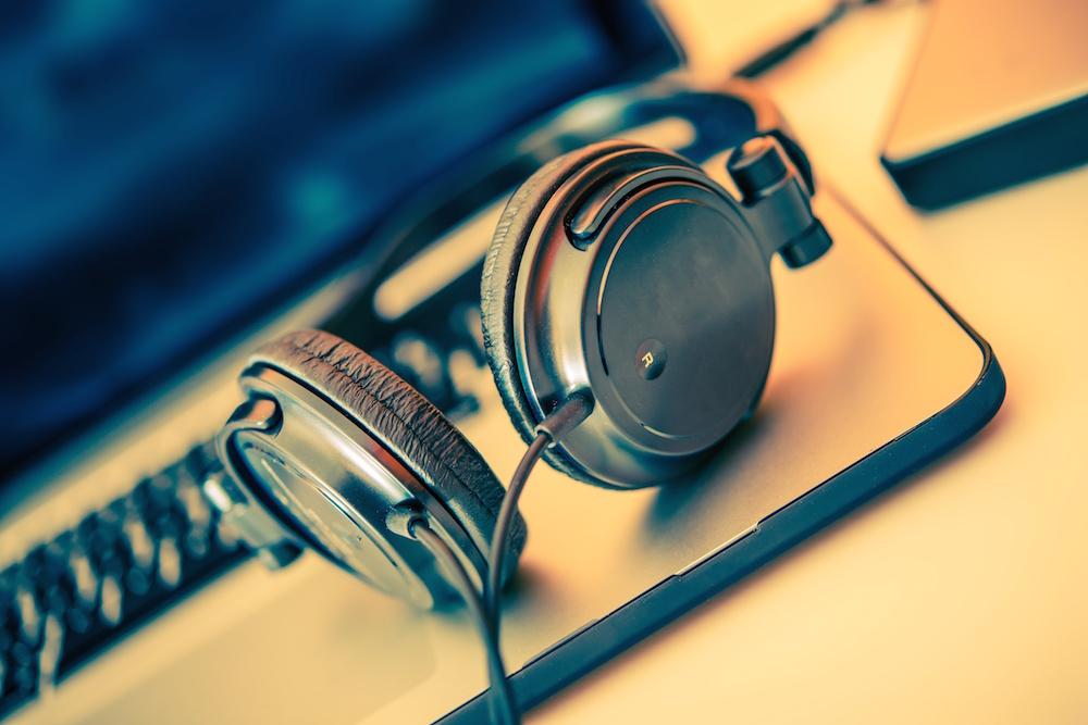 over ear headphones on open laptop